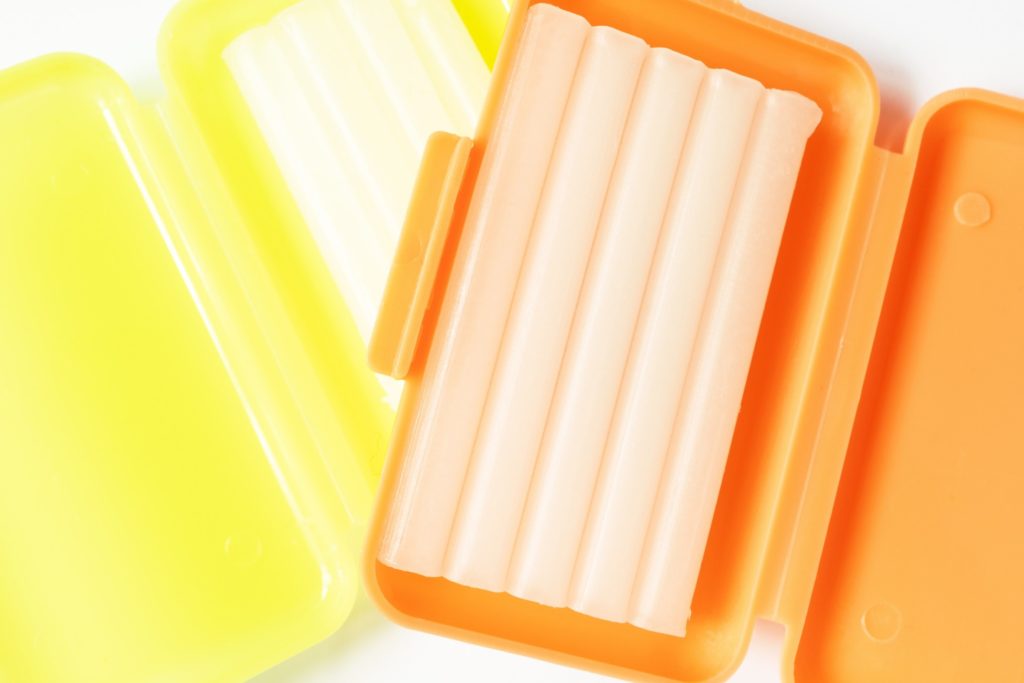 Closeup of dental wax in orange container