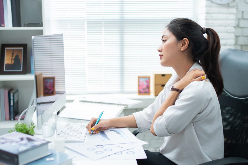 Woman slouching while working in office